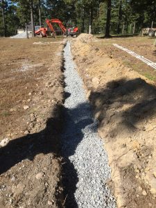 Photo of gravel filled distribution trench